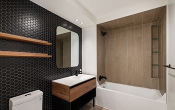 a bathroom with a sink and a tub and a mirror